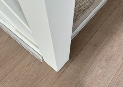 Laminate flooring finished against skirting boards in Schofields, Sydney