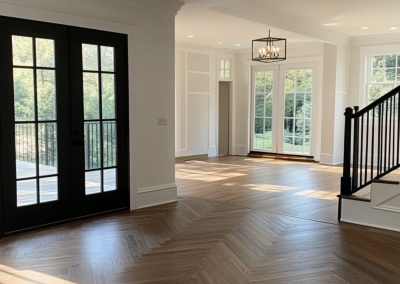 Engineered herringbone flooring through an open living area with black French doors, Rose Bay Sydney