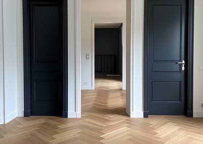Engineered herringbone flooring running down a hallway between dark navy doors, Rose Bay Sydney