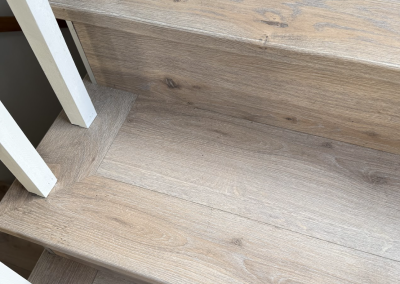 Laminate flooring finished around a stair landing and skirting in Oatley, Sydney