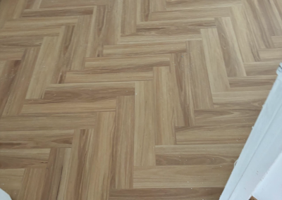 Laminate herringbone flooring in an open living space, George Hall Sydney
