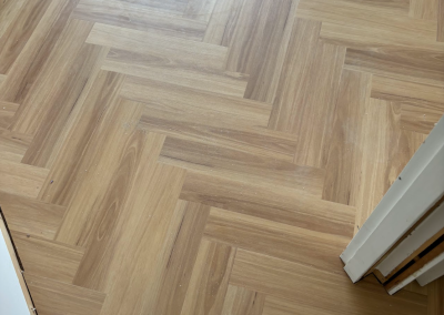 Laminate herringbone flooring fitted neatly into a room corner, George Hall Sydney
