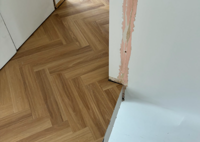 Laminate herringbone boards being cut and fitted into the herringbone pattern, George Hall Sydney