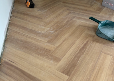 Newly installed laminate herringbone flooring being cleaned down, George Hall Sydney