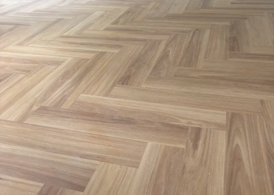 Completed laminate herringbone flooring across a large living area, George Hall Sydney