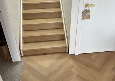 Laminate timber treads on a staircase with white risers in a Bangor home, Sydney