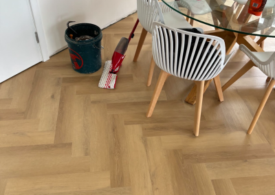 Laminate herringbone flooring in a dining area during fit-out, Bangor Sydney