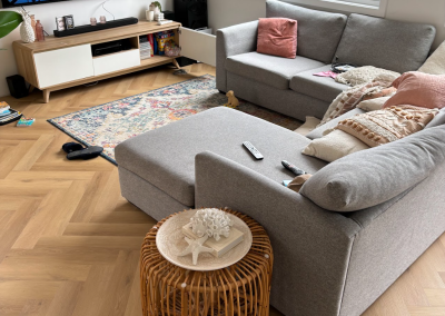 Completed laminate herringbone flooring in a furnished lounge room, Bangor Sydney