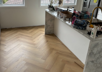 Laminate herringbone flooring running through the kitchen and hallway of a Bangor home, Sydney